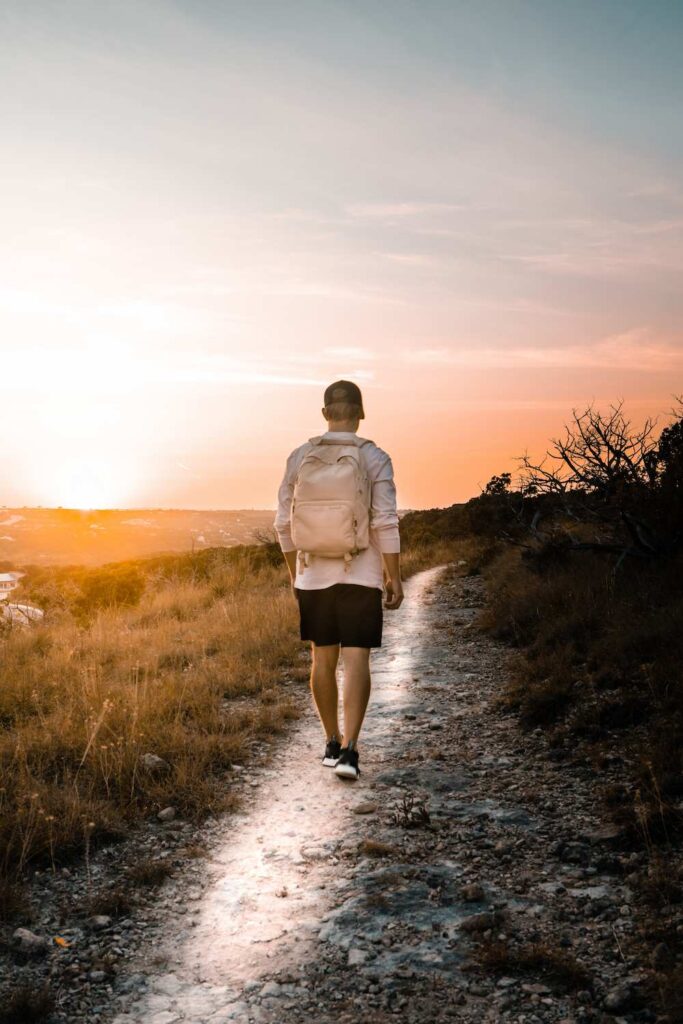 A young man walks along a path.