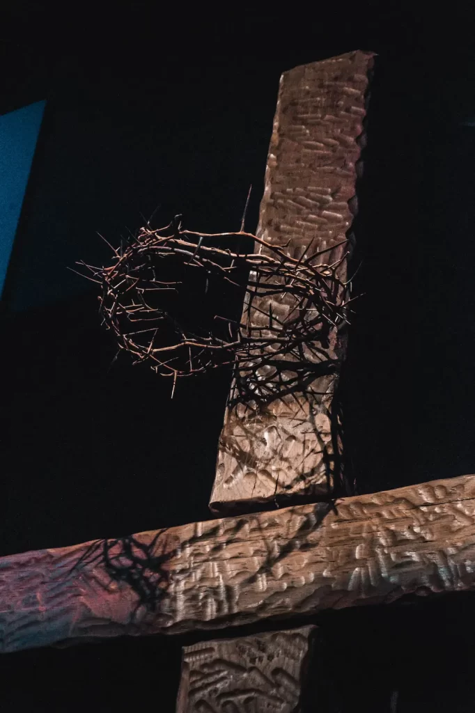 A cross representing Philippians 4:13 can be seen with a crown of thorns around it.